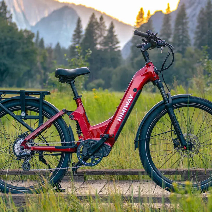 Red electric bike on a wooden path with mountains and trees in the background