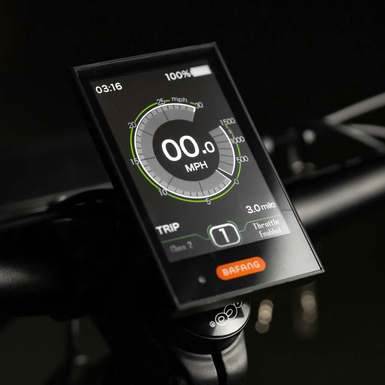 Digital speedometer display on a motorcycle handlebar with a dark background