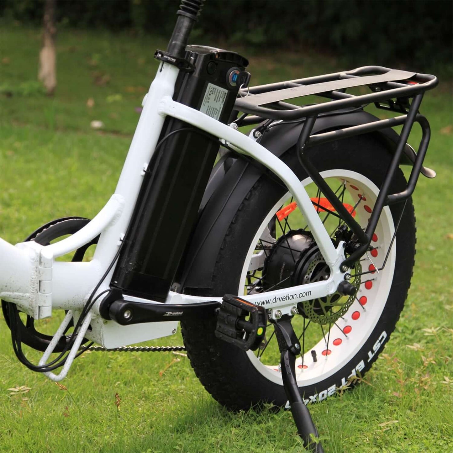 Drvetion CT20 Fat Tire Folding Electric Bike rear view with battery and tire on grass