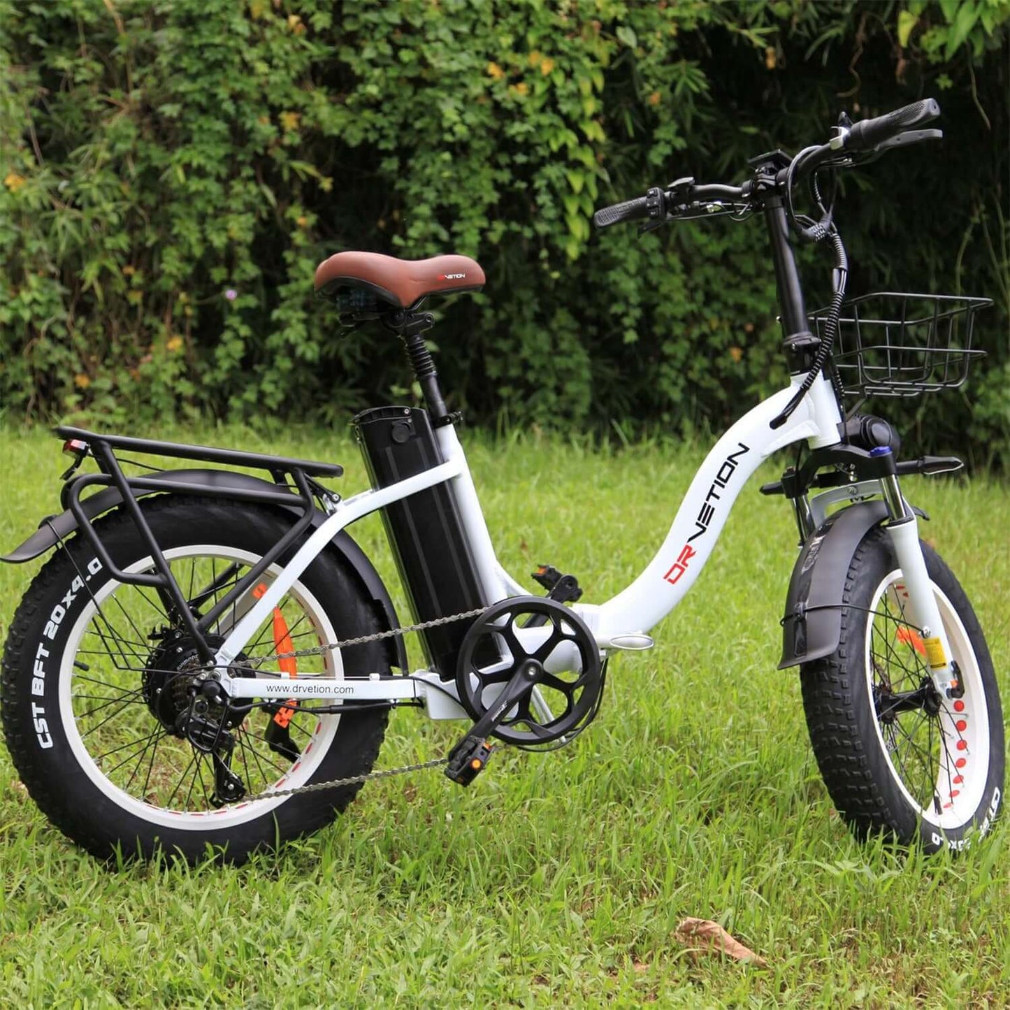 Drvetion CT20 Fat Tire Folding Electric Bike in a grassy area, showcasing its design and features.