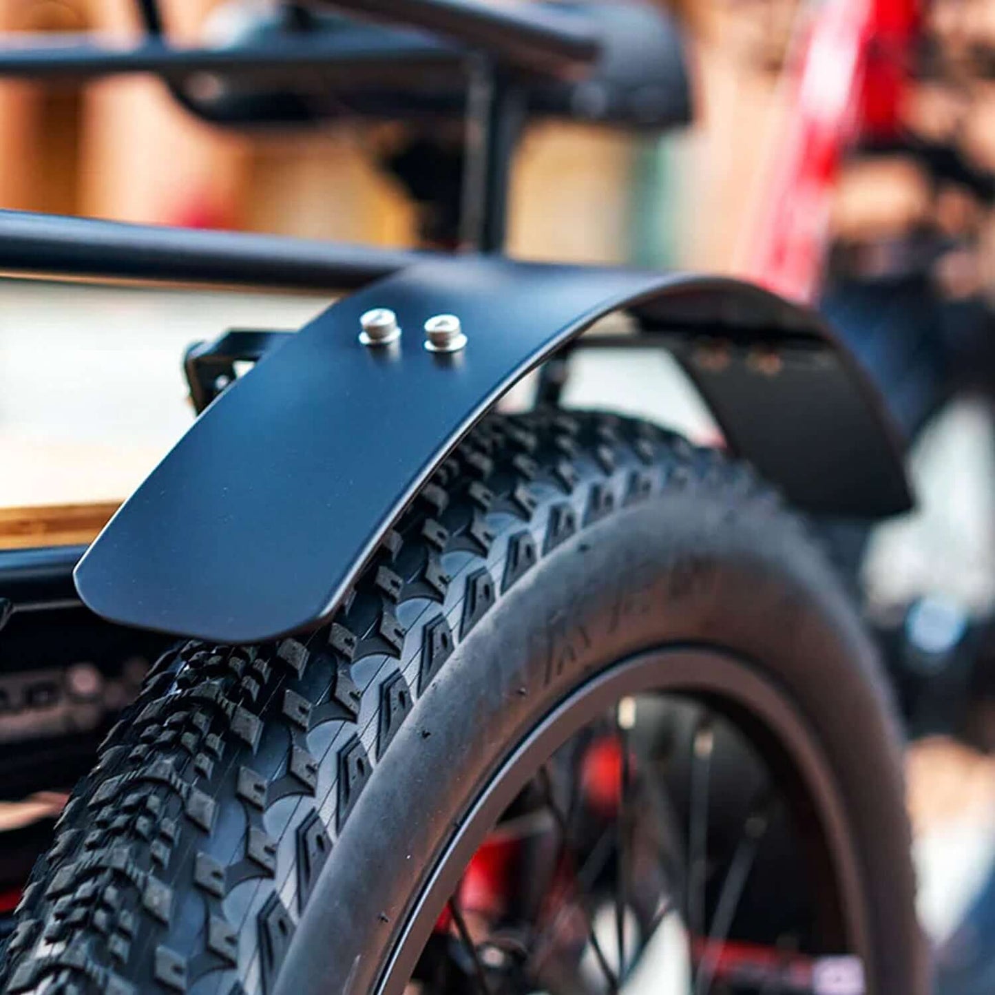 Close-up of the black fender on an Emojo Bison PRO electric trike tire, showcasing its durable design and texture.