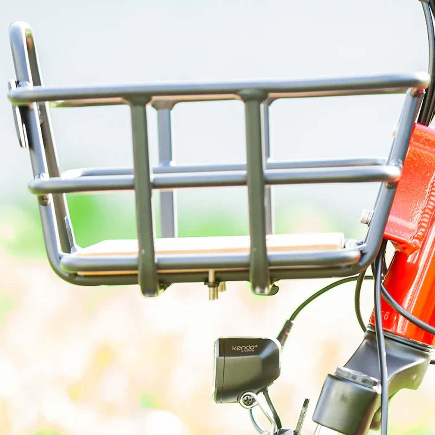 Close-up of the sturdy metal basket on the Emojo Bison PRO electric trike, ideal for carrying items.