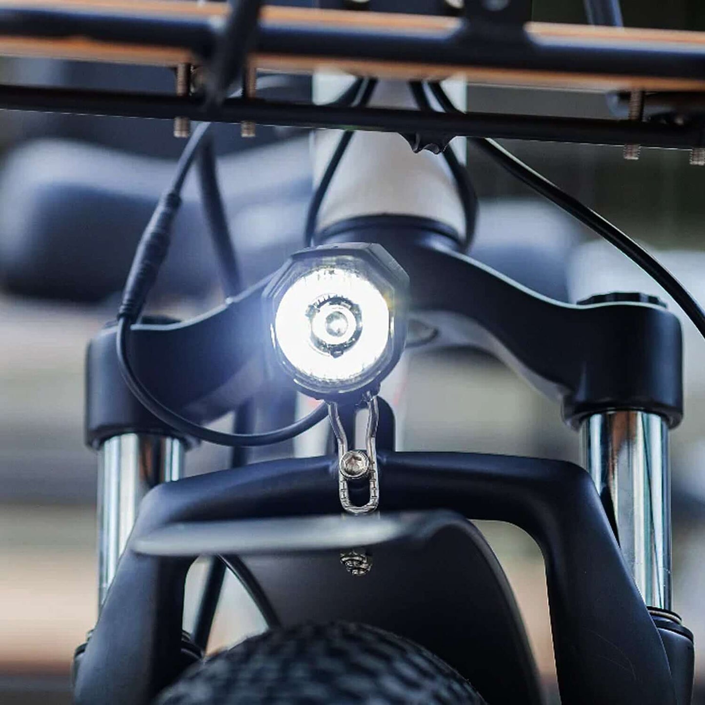 Close-up of the front light on the Emojo Bison PRO electric trike, illuminating the path ahead.