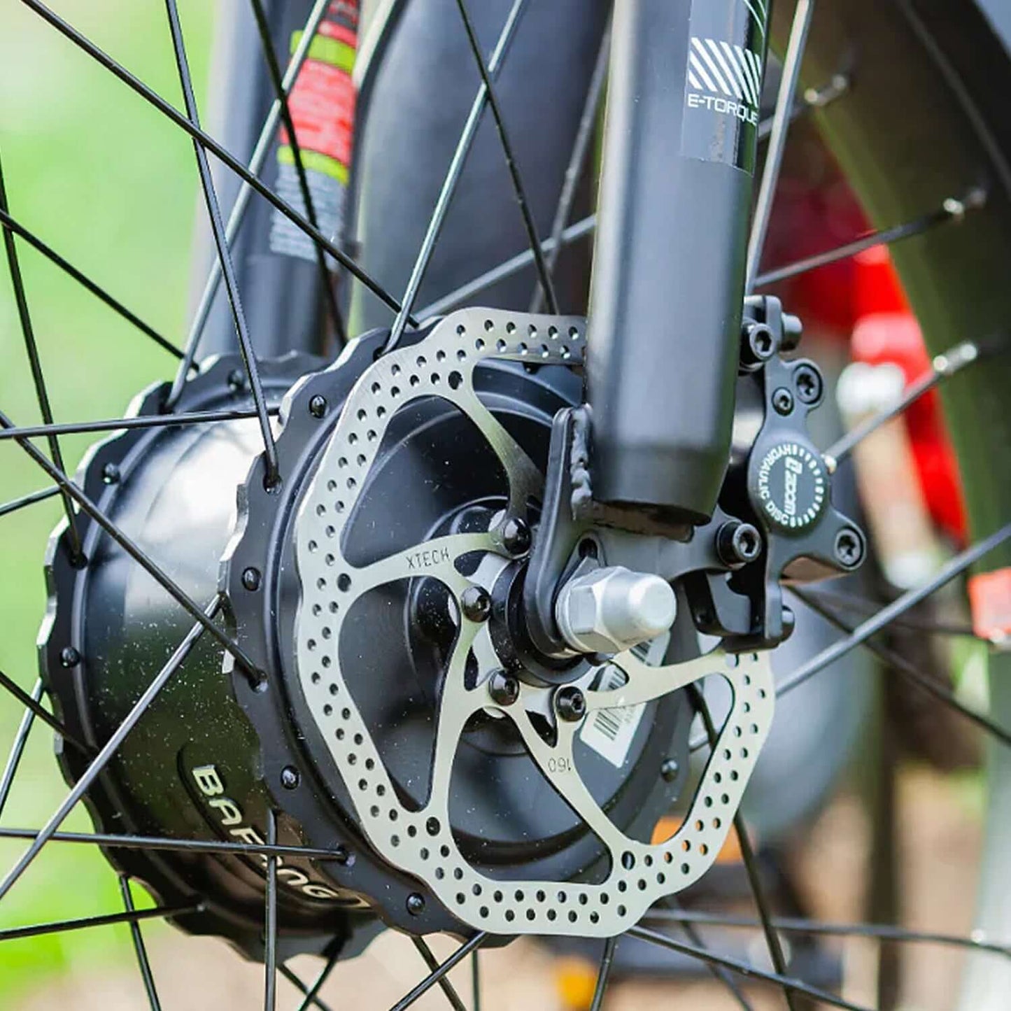 Close-up of the electric bike's rear wheel with a hub motor and disc brake components.