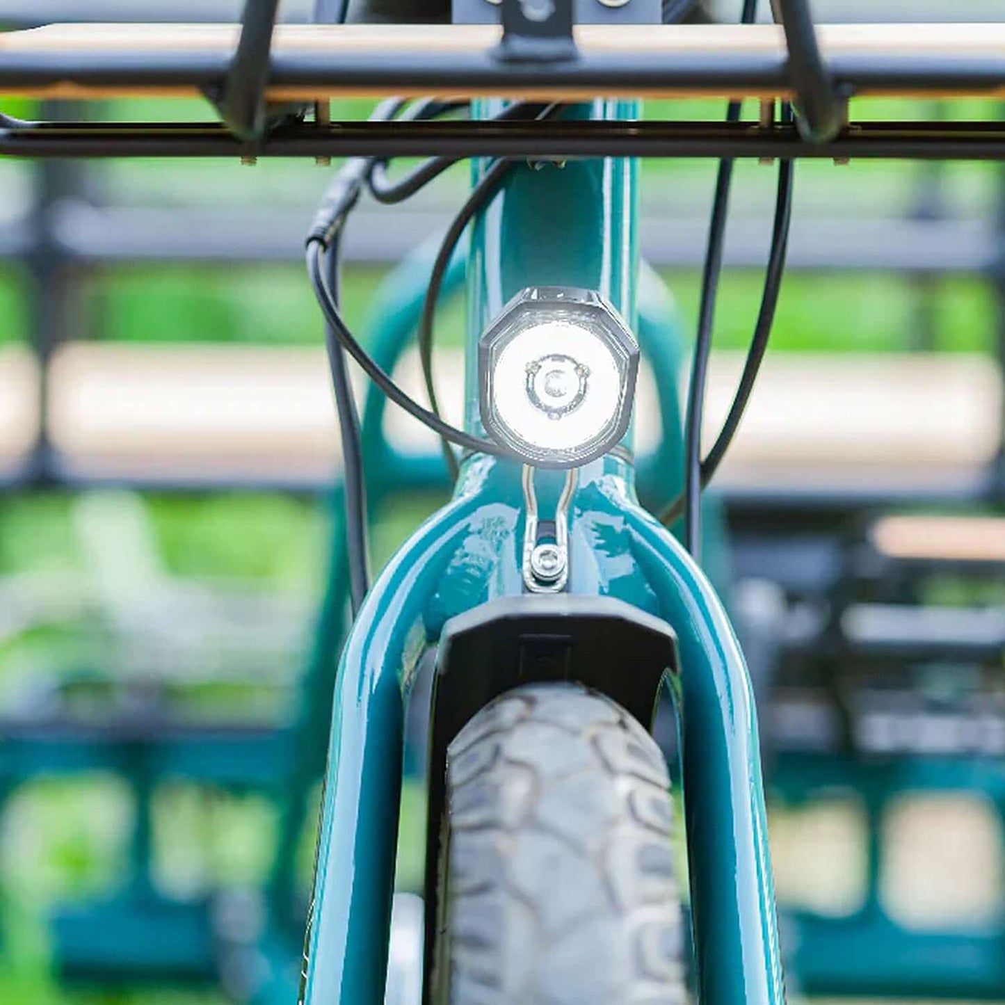 Close-up of Emojo Bison S electric trike front view, showcasing the headlight and tire.