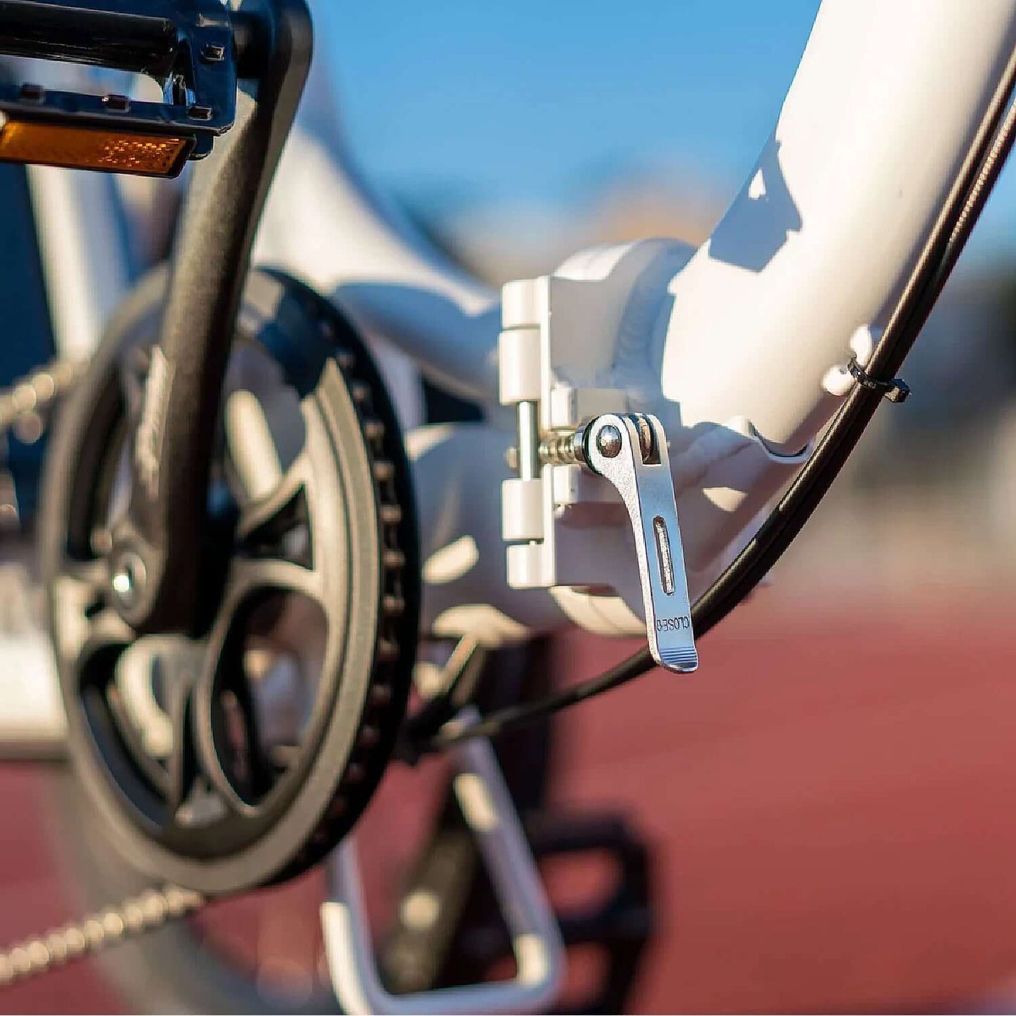 Close-up of the Emojo Bison S electric trike's step-thru design with detailed hinge and drivetrain.