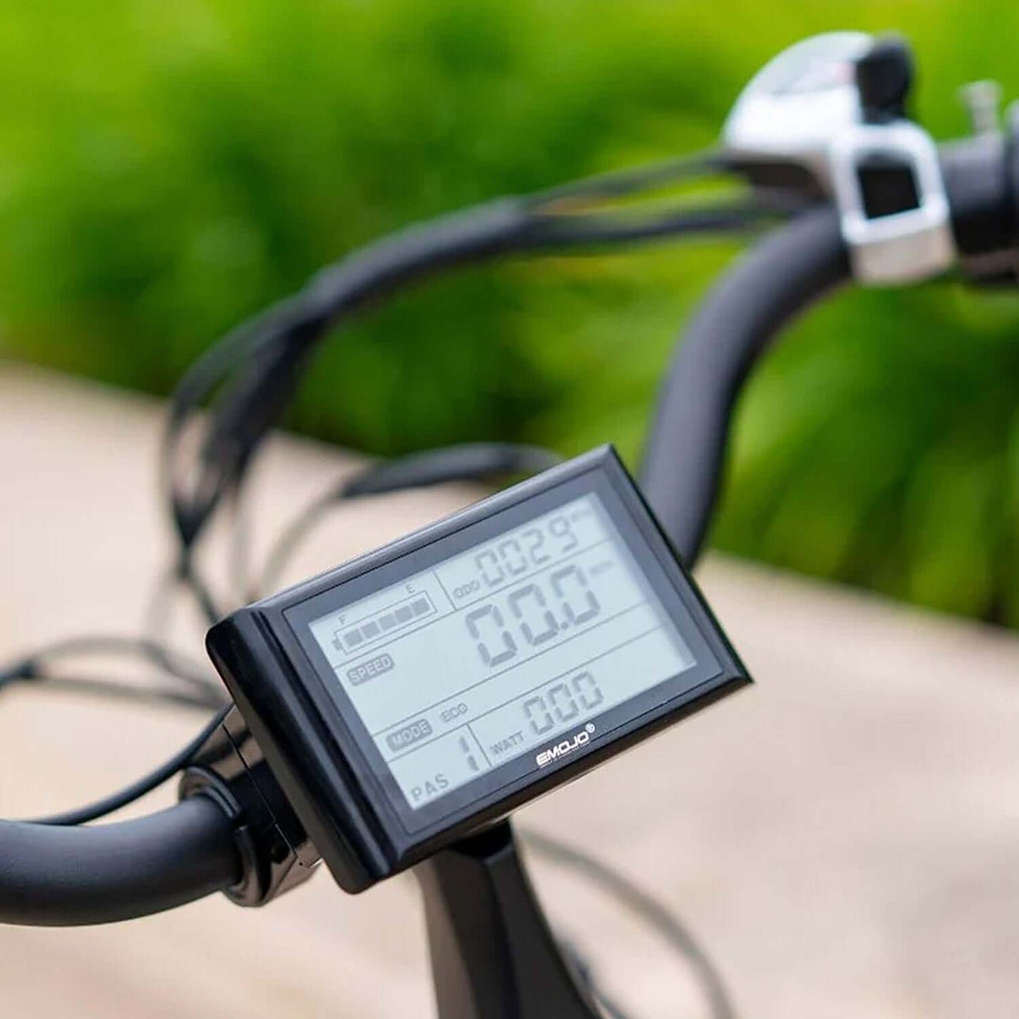 Close-up of the digital display on an Emojo electric trike showing speed and battery information.