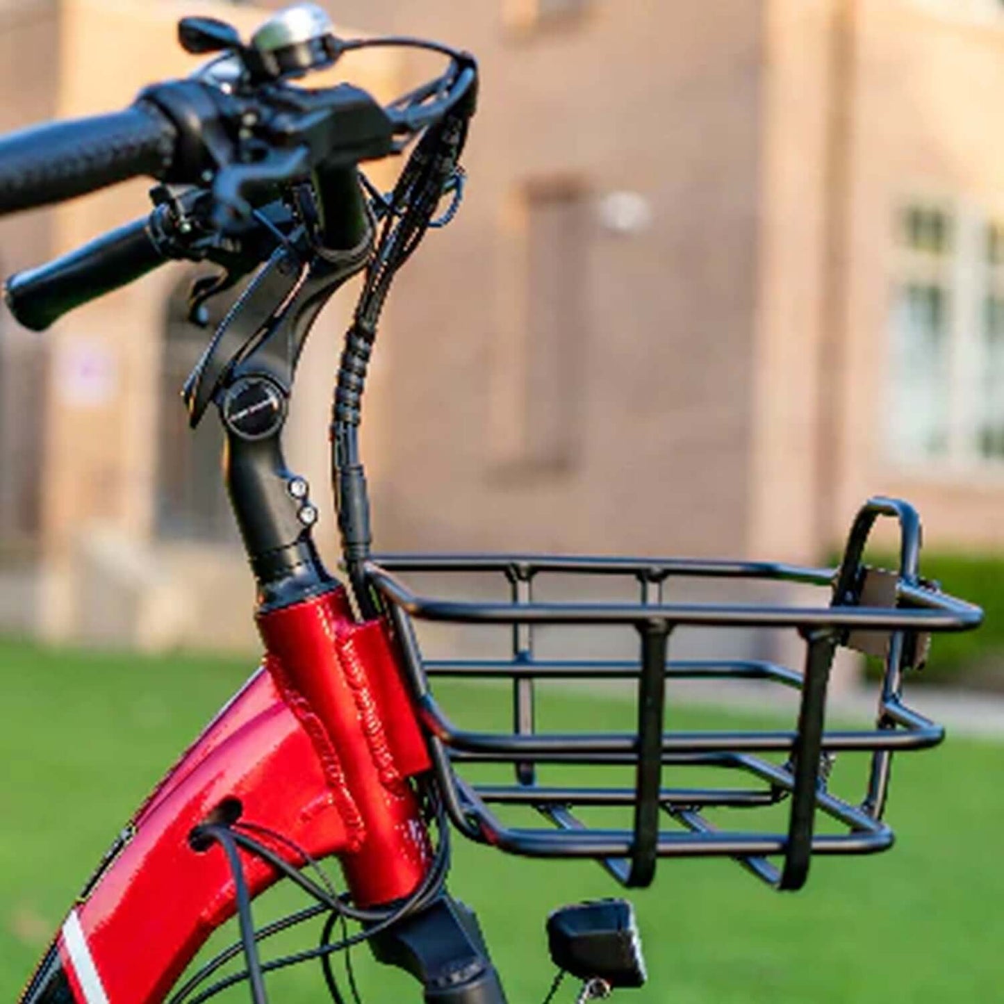 Close-up of the handlebars and black basket of the Emojo Caddy PRO 48V electric trike, showcasing its storage feature.