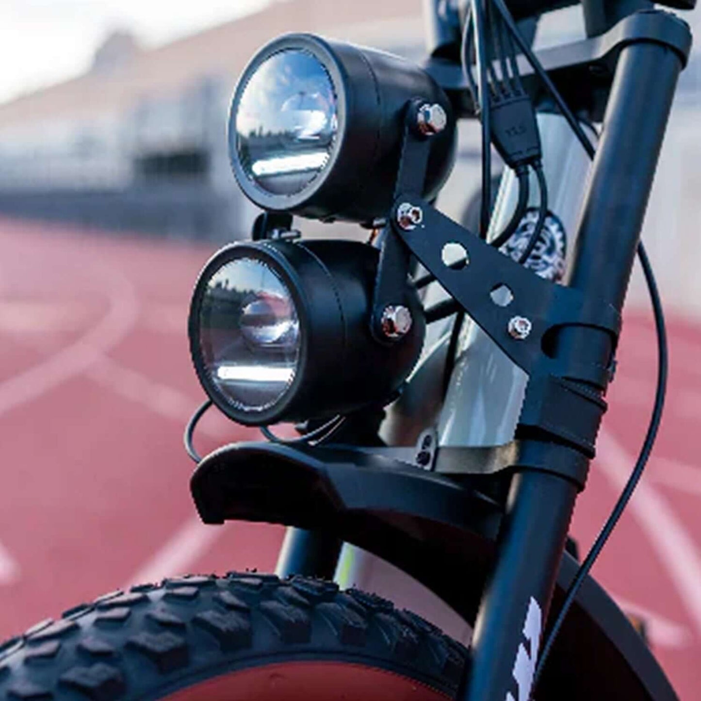 Close-up of the front lights on the Emojo Streetrod fat tire electric bike, showcasing durability and design.