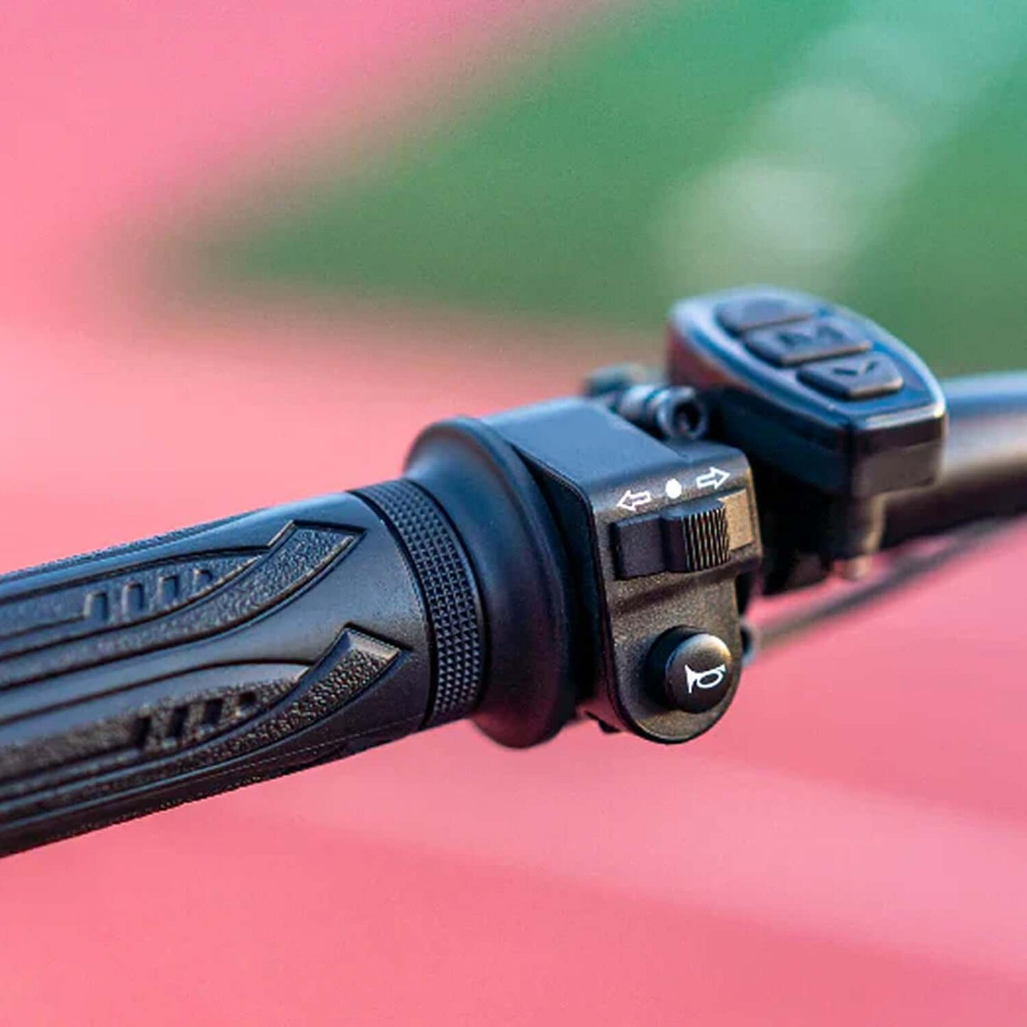 Close-up of the control panel on the handlebar of a fat tire electric bike, showcasing the throttle and buttons.