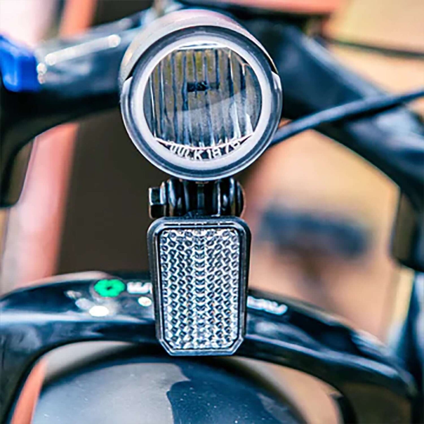 Close-up of Eunorau META electric bike headlight and reflector, showcasing its bright lighting features.