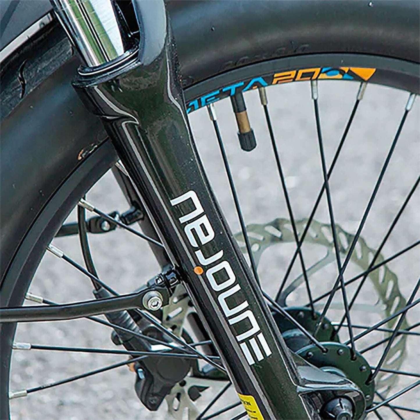 Close-up of the Eunorau META electric bike fork showcasing the wheel and brake system.