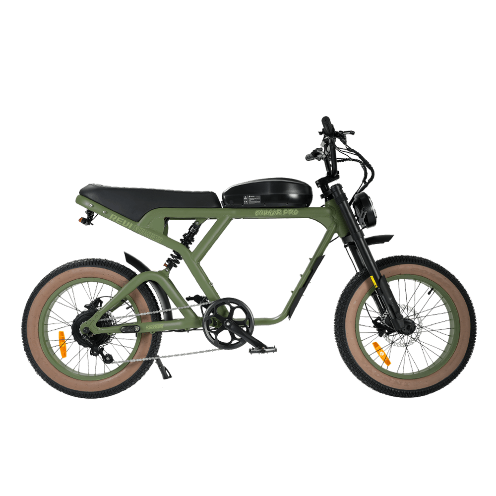 An electric bicycle with a matte olive green frame, black seat and handlebars, tan sidewall tires, and a black front suspension fork, shown on a plain white background.