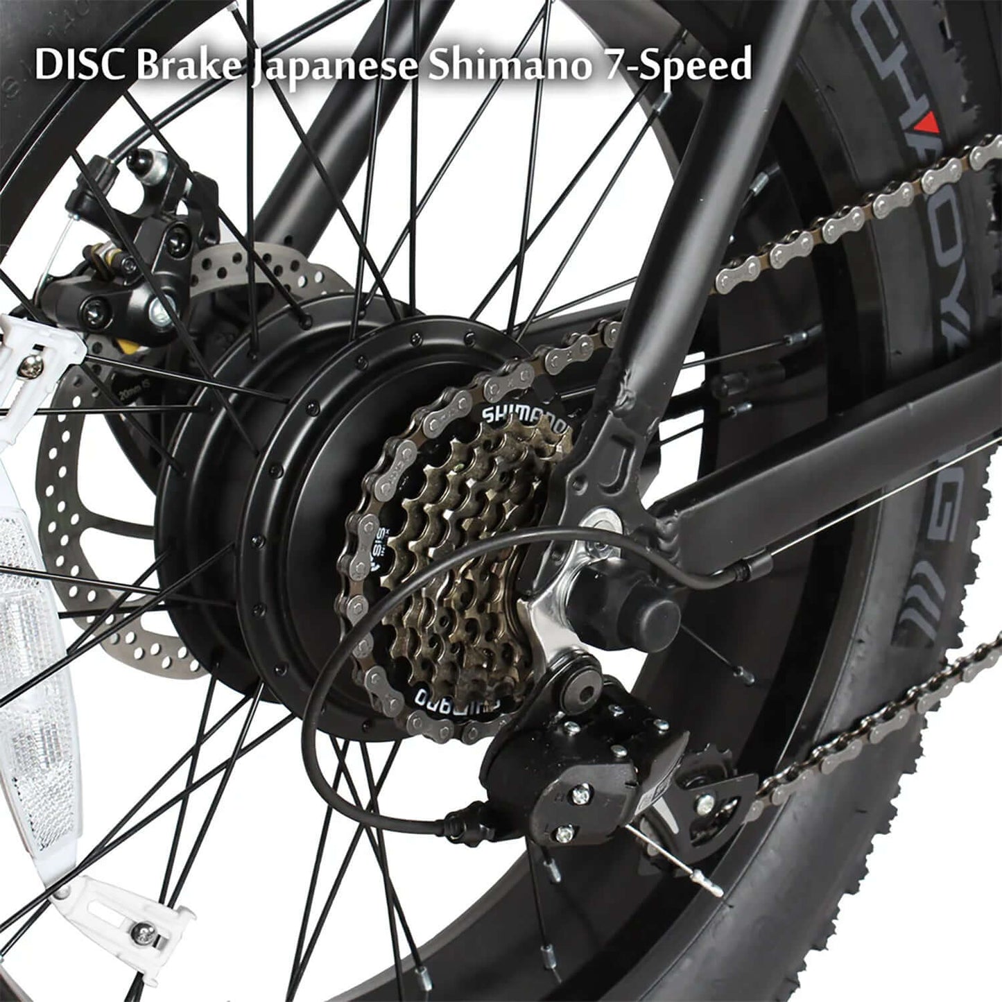 Close-up of Tracer Coyote electric bike's rear wheel with Shimano 7-speed gear and disc brake system.
