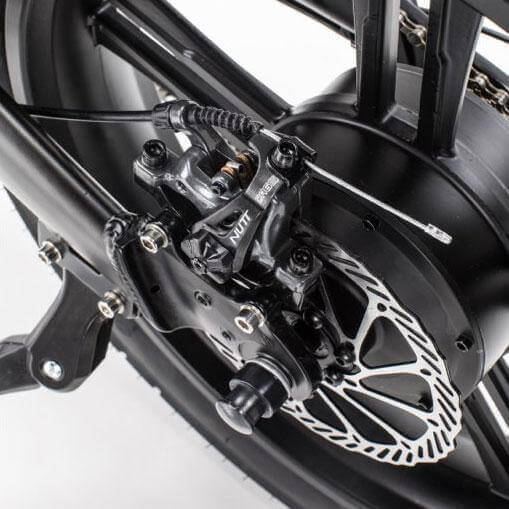 Close-up of the Qualisports electric bike's fat tire motor and brake system, showcasing precision engineering.