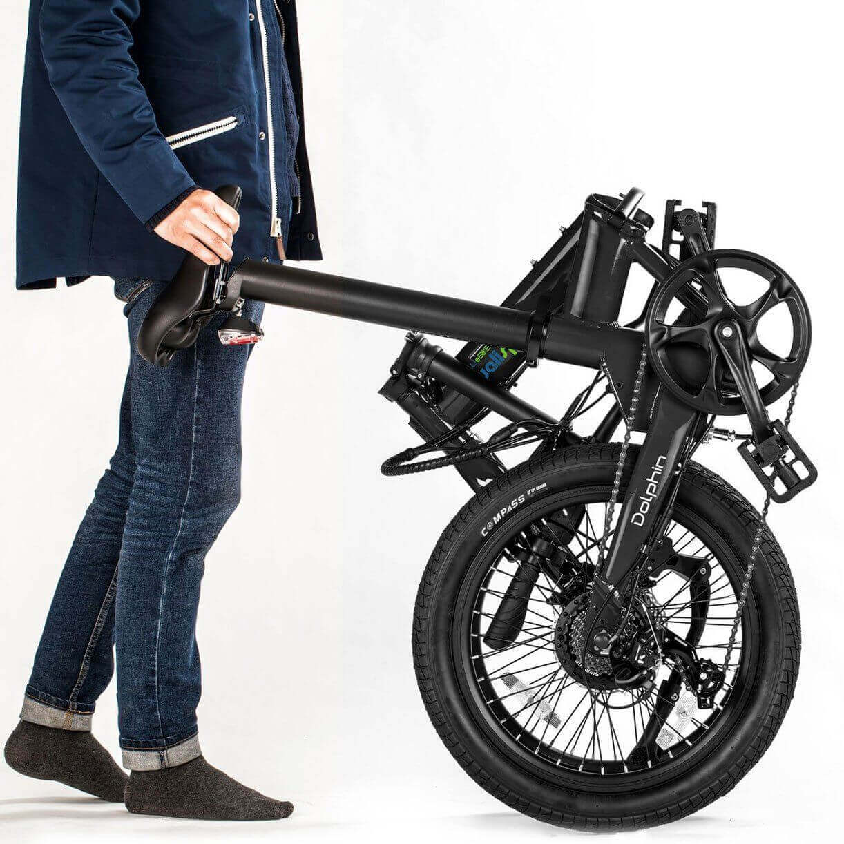 Person folding and carrying the Qualisports Dolphin Portable Beach Cruiser Electric Bike.