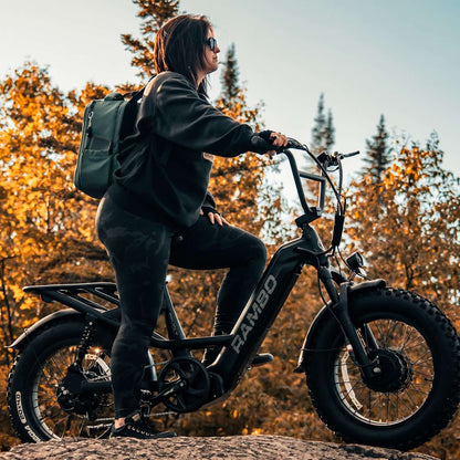 Person riding a electric bike in a forest with autumn foliage