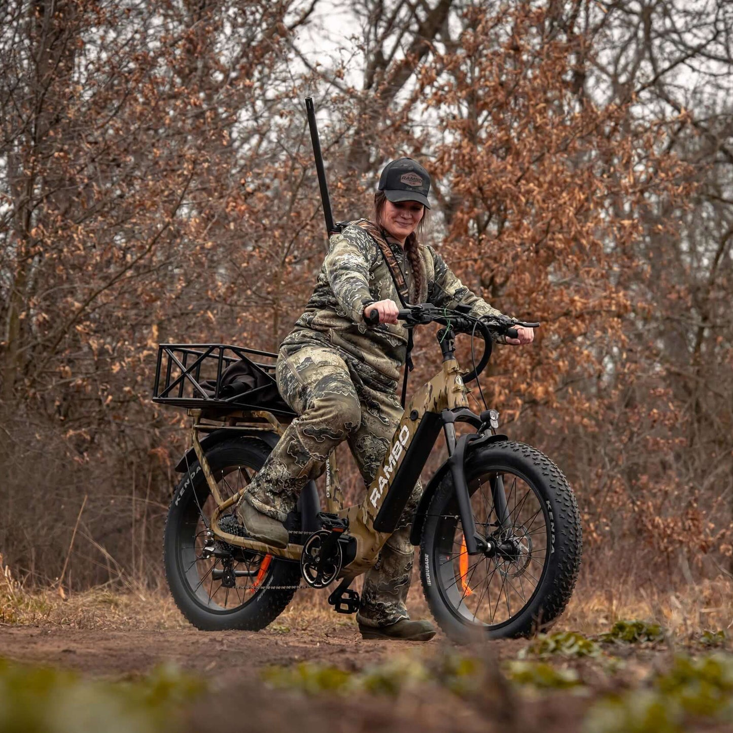 Person on a camouflage electric bike in a forest setting