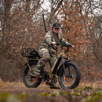 Person on a camouflage electric bike in a forest setting