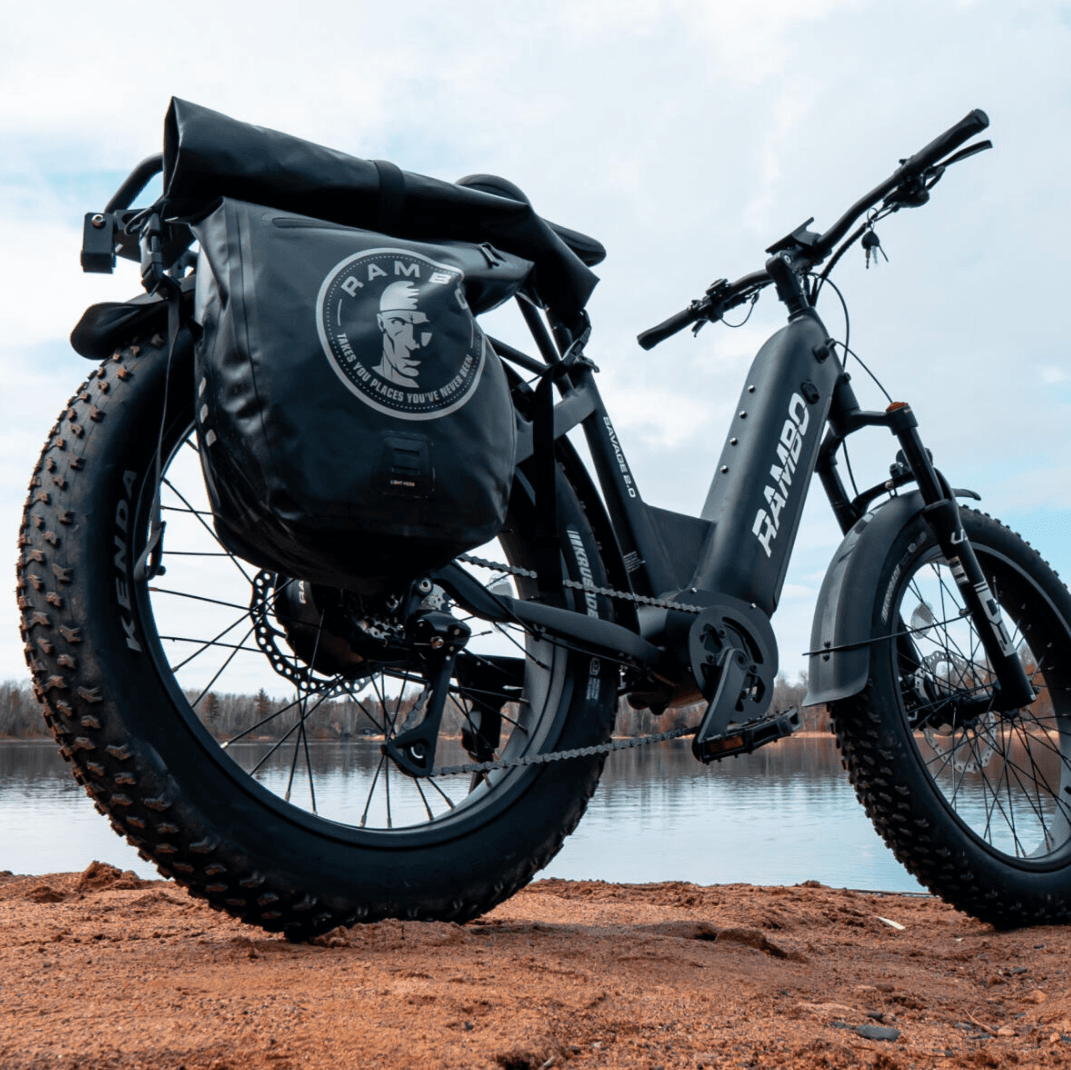 Electric bike with large tires on a dirt path near a body of water