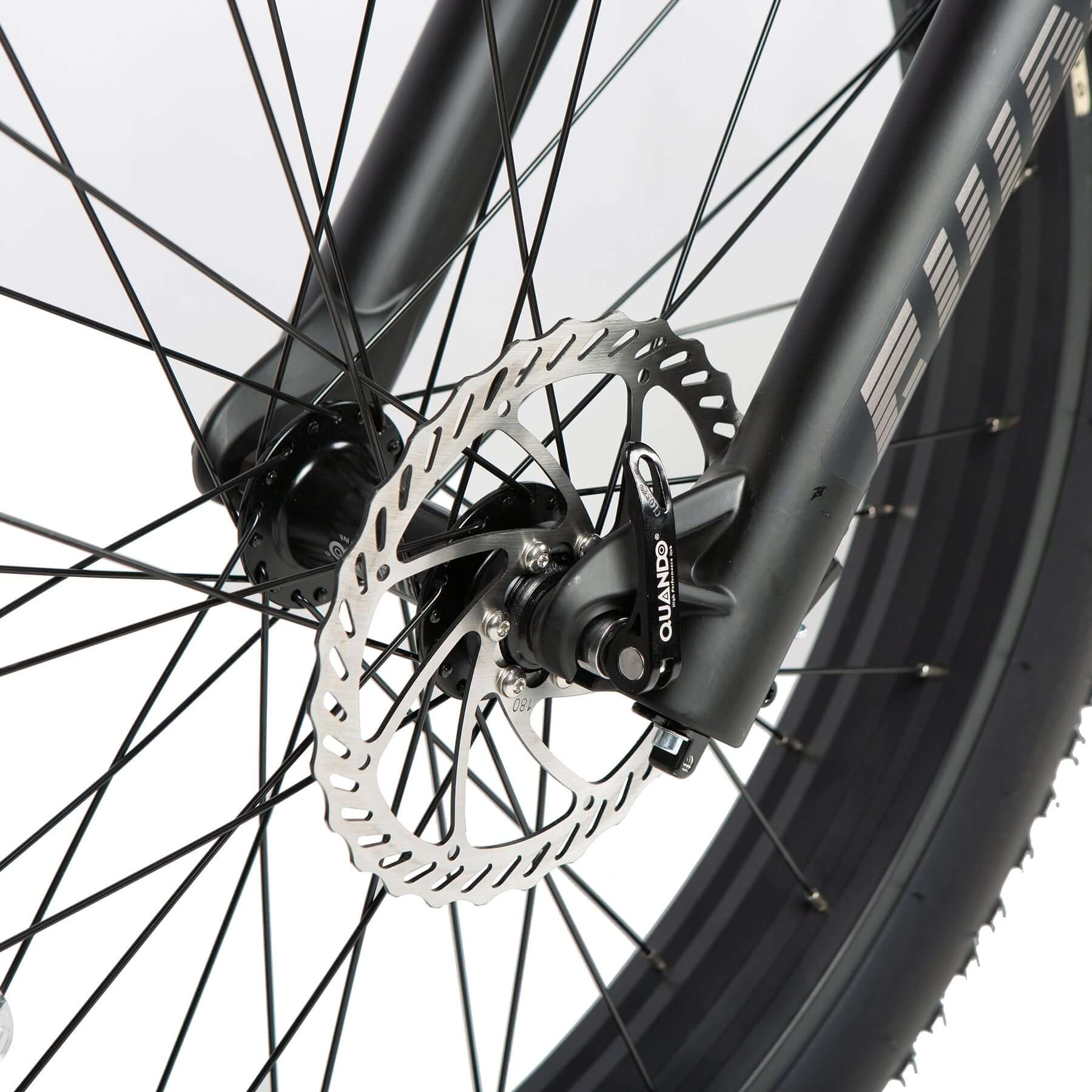 Close-up of a bicycle wheel with disc brake system on a white background