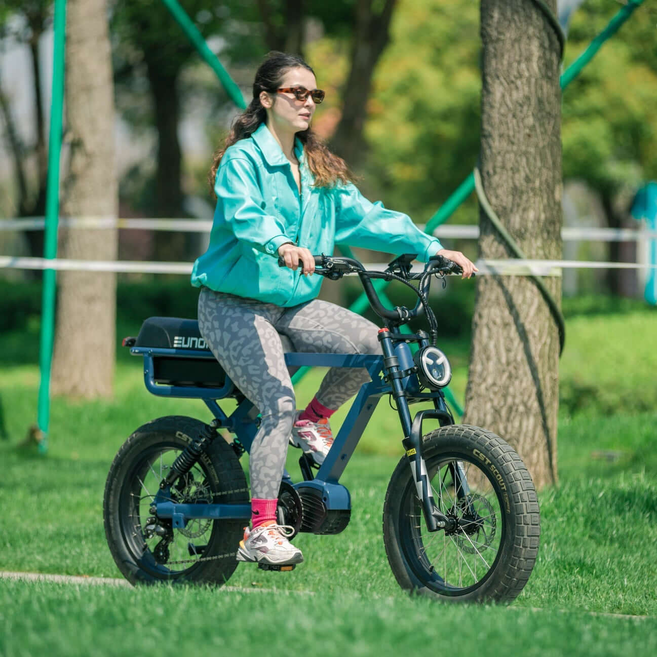 Woman riding a small electric bike in a park