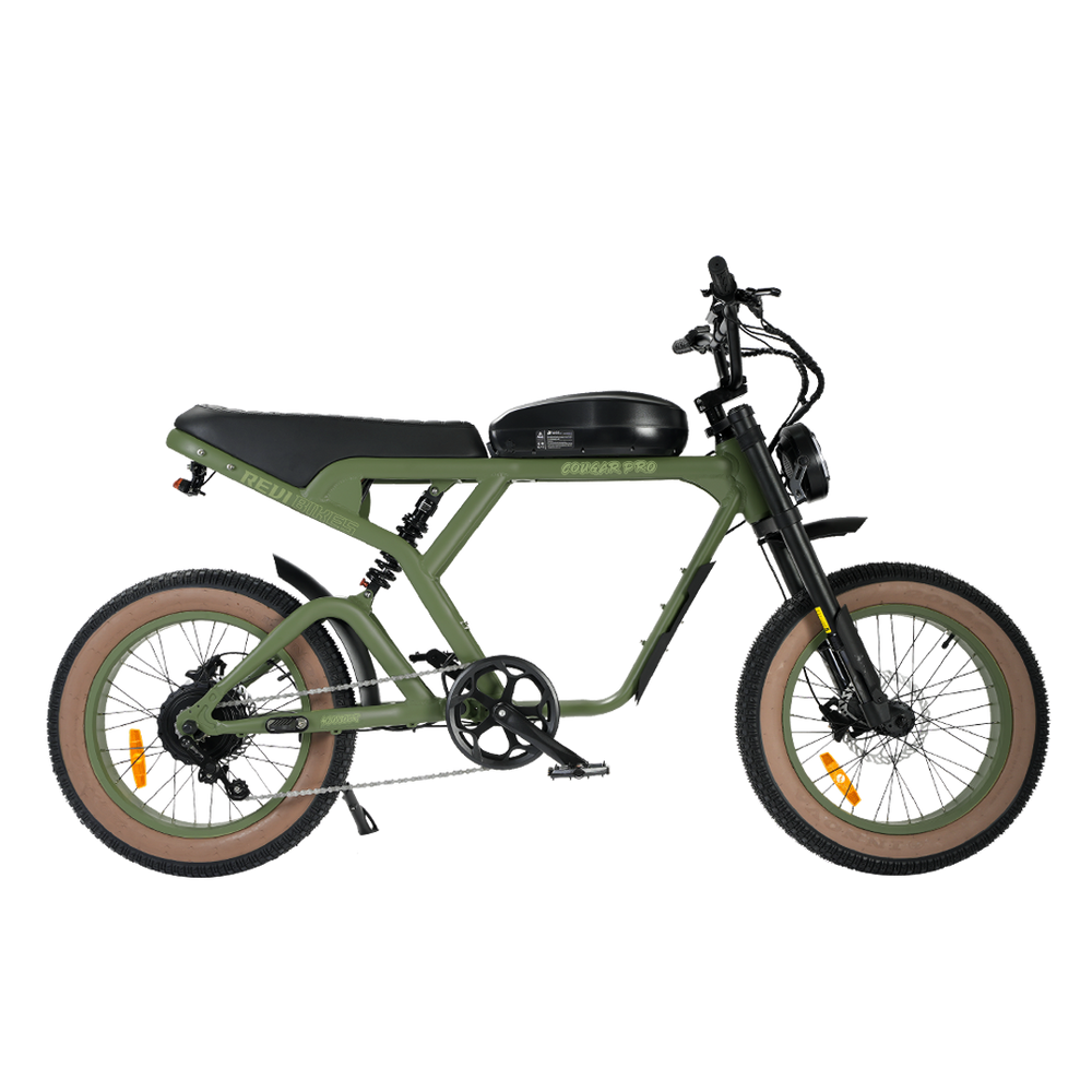 An electric bicycle with a matte olive green frame, black seat and handlebars, tan sidewall tires, and a black front suspension fork, shown on a plain white background.