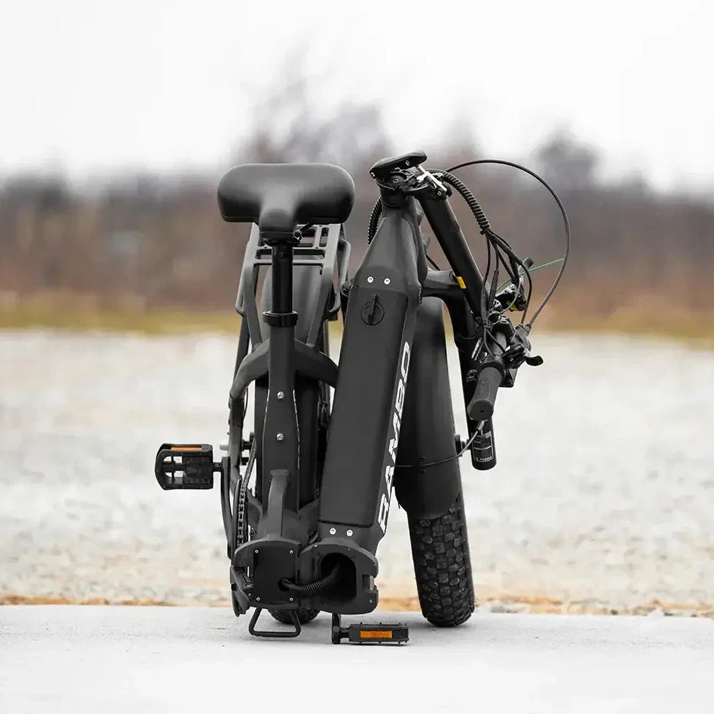 Folding electric bike on a white platform with a blurred natural background