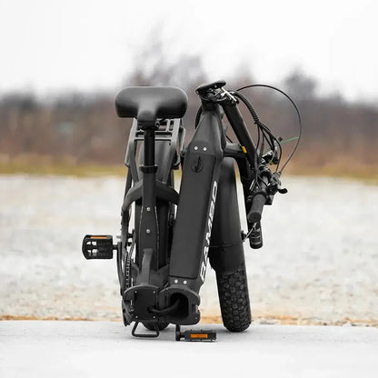 Folding electric bike on a white platform with a blurred natural background